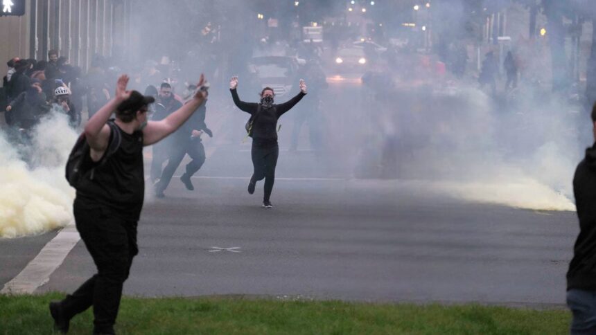 Riot at Portland ICE facility with protesters clashing with federal officers amid tear gas and smoke, June 2025.