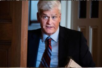 Student reviewing loan papers near U.S. Capitol amid forgiveness uncertainty
